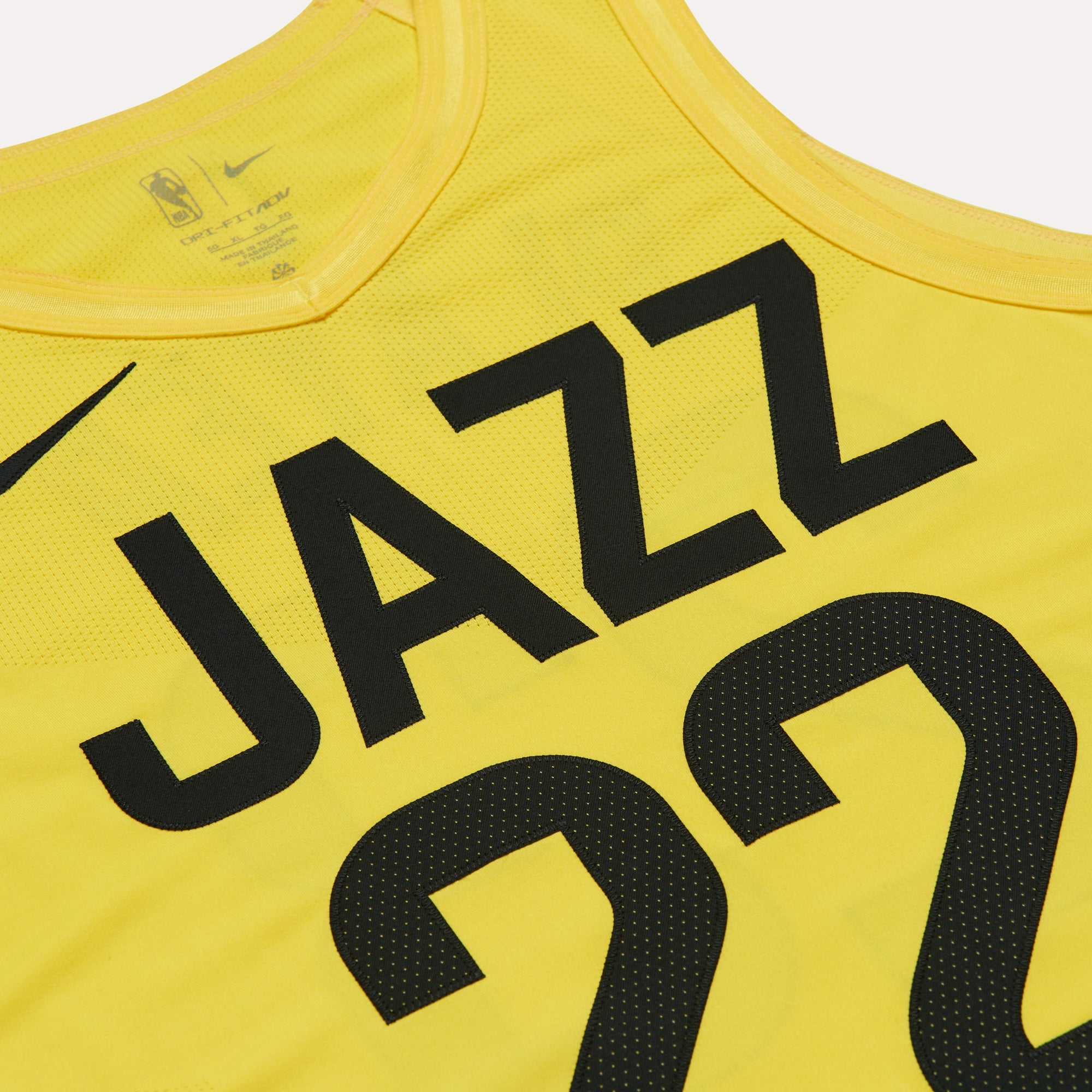 Close up shot of the yellow Nike jersey with black accents of JAZZ wordmark and the number 22
